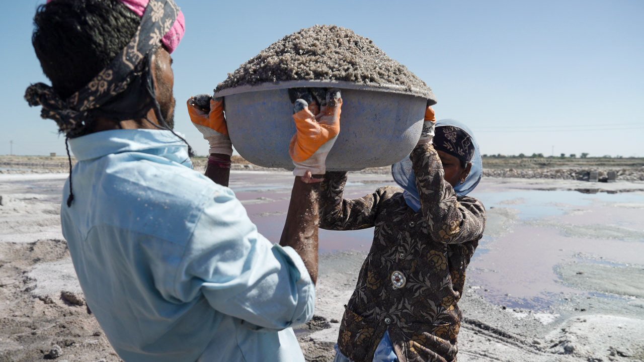 Workers carrying salt